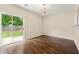 Living room with hardwood floors, modern chandelier, and sliding glass doors to the outside at 1343 Penhurst Dr, Lawrenceville, GA 30043