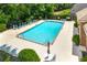 Aerial shot of a community pool surrounded by lounge chairs and lush greenery at 1343 Penhurst Dr, Lawrenceville, GA 30043