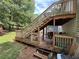 Multi-level back deck with stairs leading to yard and outdoor seating area at 135 Woodcrest Dr, Covington, GA 30016