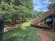 Expansive backyard featuring mature trees, deck with stairs, and a peaceful setting at 135 Woodcrest Dr, Covington, GA 30016