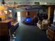 Finished basement featuring couches, a TV, and unique decorative license plates at 135 Woodcrest Dr, Covington, GA 30016