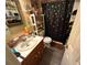 Bathroom features vanity with sink, toilet, shelves, and dark shower curtain with silver spiders at 135 Woodcrest Dr, Covington, GA 30016