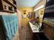 Bathroom features double vanity, ample lighting, custom cabinets, and a large mirror at 135 Woodcrest Dr, Covington, GA 30016