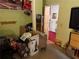 Bedroom features green walls and includes various stored items such as boxes and a vacuum cleaner at 135 Woodcrest Dr, Covington, GA 30016