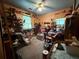 Cluttered bedroom with carpet and an overflowing collection of items, creating an organized mess at 135 Woodcrest Dr, Covington, GA 30016