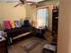 Bedroom with pastel-colored walls and a bed, filled with a collection of various items at 135 Woodcrest Dr, Covington, GA 30016