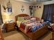 Cozy bedroom featuring a decorative quilt bedspread, a lamp, and dreamcatchers as decor at 135 Woodcrest Dr, Covington, GA 30016