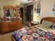 Cozy bedroom featuring a decorative quilt bedspread, a lamp, and dreamcatchers as decor at 135 Woodcrest Dr, Covington, GA 30016