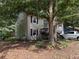Side view of a two-story home with a large yard and mature trees at 135 Woodcrest Dr, Covington, GA 30016