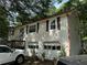 Two-story home with a garage and a quaint, inviting facade at 135 Woodcrest Dr, Covington, GA 30016