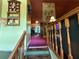 View from foyer toward living room with stone fireplace and wood accents at 135 Woodcrest Dr, Covington, GA 30016
