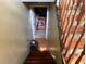 Carpeted staircase leading down to a finished basement with decorative wood-look flooring at 135 Woodcrest Dr, Covington, GA 30016