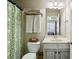 Charming bathroom features a patterned shower curtain and ample storage space at 7275 Highland Blf # 8, Atlanta, GA 30328