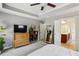 Bright bedroom featuring a tray ceiling, and a doorway leading to the bathroom at 7275 Highland Blf # 8, Atlanta, GA 30328