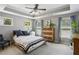 Comfortable bedroom with tray ceilings, two windows, and a chest of drawers at 7275 Highland Blf # 8, Atlanta, GA 30328