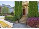 Welcoming townhome entrance with landscaped shrubs leading to the front door and exterior details at 7275 Highland Blf # 8, Atlanta, GA 30328