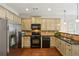 The kitchen features stainless steel appliances, light cabinetry, and sleek countertops at 7275 Highland Blf # 8, Atlanta, GA 30328