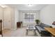 Cozy living room features a futon, area rug, natural light from window, and neutral color scheme at 7275 Highland Blf # 8, Atlanta, GA 30328