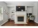 Cozy living room with a modern fireplace and built-in shelves for ample storage at 7275 Highland Blf # 8, Atlanta, GA 30328