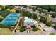 Aerial view of community amenities including tennis courts, pool, clubhouse, and playground at 1025 Pebble Creek Trl, Suwanee, GA 30024