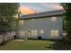 Rear exterior of home with spacious yard perfect for outdoor activities and entertaining at 1025 Pebble Creek Trl, Suwanee, GA 30024