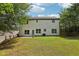 Back exterior showing a two-story home with large windows and a well-maintained lawn at 1025 Pebble Creek Trl, Suwanee, GA 30024