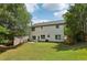 Spacious backyard showcasing lush green lawn and the back of a two-story home at 1025 Pebble Creek Trl, Suwanee, GA 30024