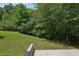 Spacious backyard with lush green grass, mature trees and landscaping, perfect for outdoor relaxation and entertaining at 1025 Pebble Creek Trl, Suwanee, GA 30024