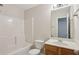 Bathroom featuring a tub, wood vanity, updated sink and fixtures, and a framed mirror at 1025 Pebble Creek Trl, Suwanee, GA 30024