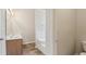 Bathroom with wood-look flooring, a soaking tub, dual vanity, and neutral paint at 1025 Pebble Creek Trl, Suwanee, GA 30024