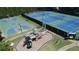 Aerial view showcasing the community's recreational amenities including tennis courts, basketball court, and playground at 1025 Pebble Creek Trl, Suwanee, GA 30024