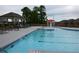 Relaxing community pool area with comfortable lounge chairs and a fun splash fountain at 1025 Pebble Creek Trl, Suwanee, GA 30024