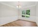 Bright dining room with large window, chair rail, and plank flooring at 1025 Pebble Creek Trl, Suwanee, GA 30024