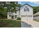 Charming two-story home with a well-maintained lawn and a two-car garage at 1025 Pebble Creek Trl, Suwanee, GA 30024