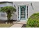 Stylish blue front door with sidelights and decorative brick edging landscaping at 1025 Pebble Creek Trl, Suwanee, GA 30024