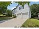 Front exterior view of a two-story home with a two-car garage and well-kept lawn at 1025 Pebble Creek Trl, Suwanee, GA 30024