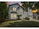 Charming two-story home featuring a manicured front yard and beautiful landscaping at 1025 Pebble Creek Trl, Suwanee, GA 30024