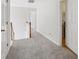Well-lit upstairs hallway featuring neutral carpeting and freshly painted white walls at 1025 Pebble Creek Trl, Suwanee, GA 30024