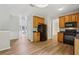 Well-lit kitchen with wood cabinets, black appliances, and plank flooring at 1025 Pebble Creek Trl, Suwanee, GA 30024