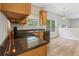 Bright kitchen featuring wood cabinets, black appliances, and granite countertops at 1025 Pebble Creek Trl, Suwanee, GA 30024