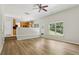 Bright open concept living space with view of kitchen, featuring wood-look flooring at 1025 Pebble Creek Trl, Suwanee, GA 30024