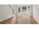 Inviting entry way, featuring a staircase, ample light, and beautiful plank flooring at 1025 Pebble Creek Trl, Suwanee, GA 30024