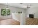 Bright living room with a fireplace, natural light, and plank flooring at 1025 Pebble Creek Trl, Suwanee, GA 30024