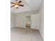 Main bedroom featuring neutral carpeting, a lighted fan, and en-suite bathroom access at 1025 Pebble Creek Trl, Suwanee, GA 30024