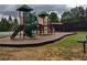 Community playground with play structures, slides, and a soft landing surface for to enjoy at 1025 Pebble Creek Trl, Suwanee, GA 30024