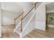 Carpeted staircase featuring wood railings, leading to the second floor and adjacent rooms at 1025 Pebble Creek Trl, Suwanee, GA 30024