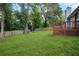 Expansive backyard with a wooden deck and mature trees at 1181 Mannbrook Dr, Stone Mountain, GA 30083
