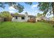 Backyard featuring a spacious lawn and a wooden fence at 1181 Mannbrook Dr, Stone Mountain, GA 30083