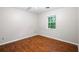Bright bedroom with hardwood floors, a window, and neutral-colored walls at 1181 Mannbrook Dr, Stone Mountain, GA 30083