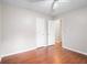 Bedroom featuring wood flooring, a ceiling fan, and access to two other rooms at 1181 Mannbrook Dr, Stone Mountain, GA 30083